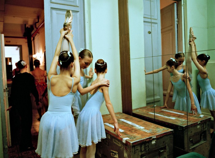 Trio of dancers in front of mirror