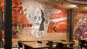 "Coming to the City" (2011), a site-specific mosaic artwork by Clive van den Berg in Nando's Kings Cross London restaurant.